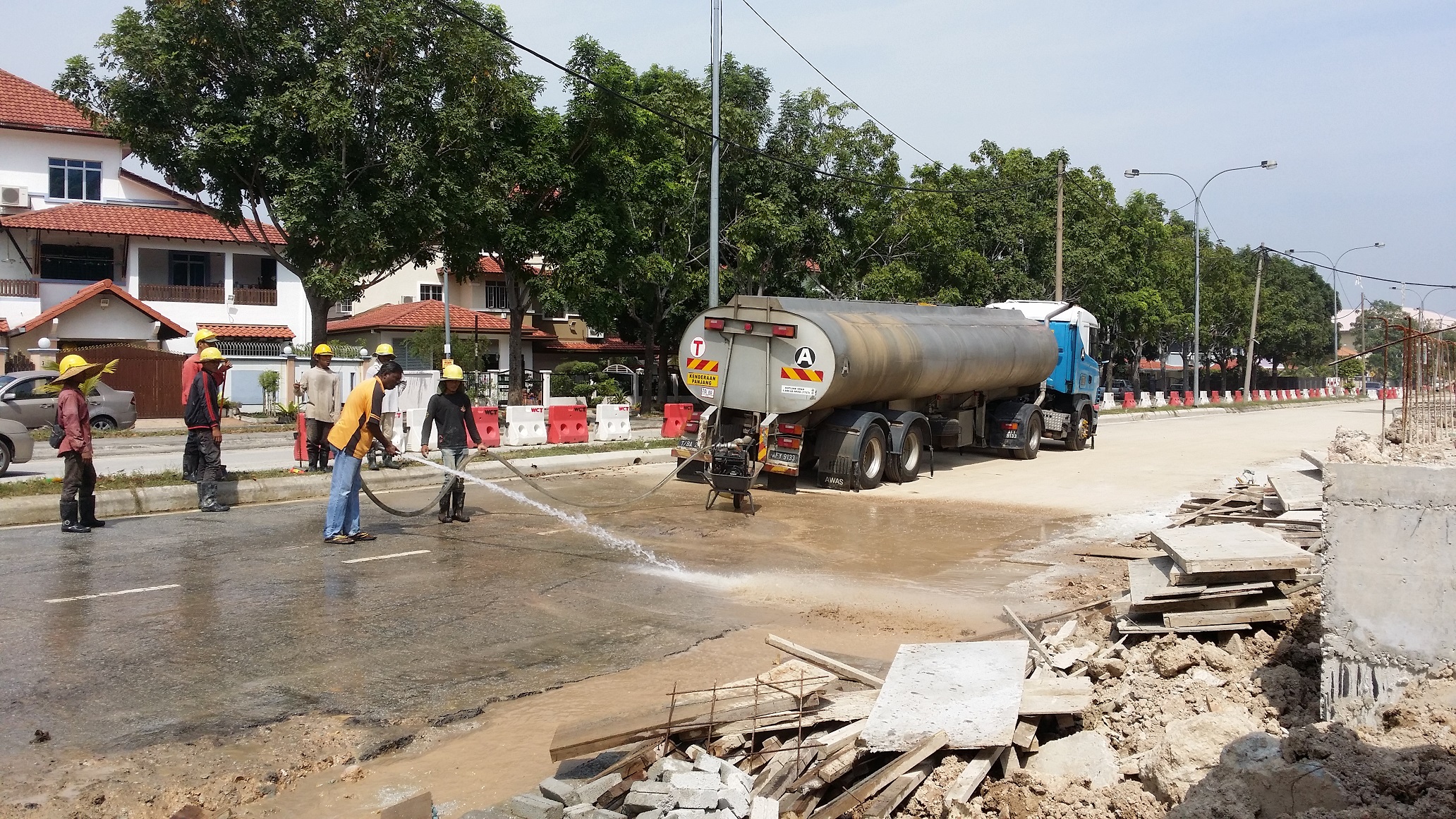 Water tanker supporting road washdown at a construction site
